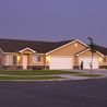 Single-level twin homes with two-car garages at dusk