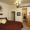 Bedroom with ceiling fan and open doorway