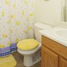 Bathroom with tub and shower combo and oak vanity
