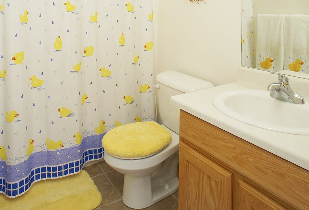 Bathroom with tub and shower combo and oak vanity