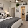 Staged primary bedroom with ceiling fan and dresser