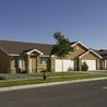 Twin homes with two-car garages and landscaped yards