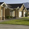 Row of home entries with stone accents and mountain views