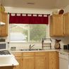 Kitchen with oak cabinets, gas range, and window over the sink